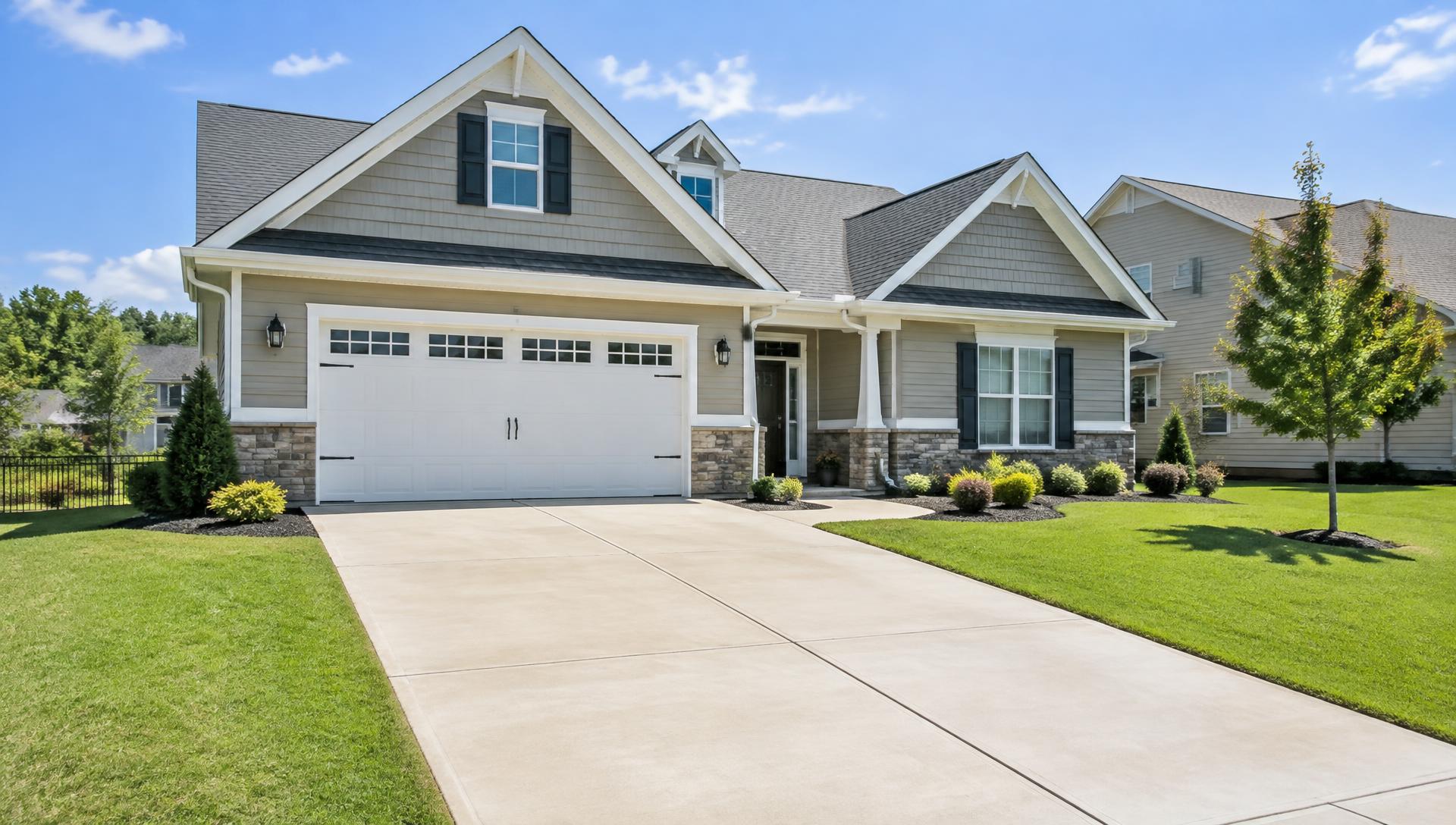 Home with a freshly pressure washed concrete driveway