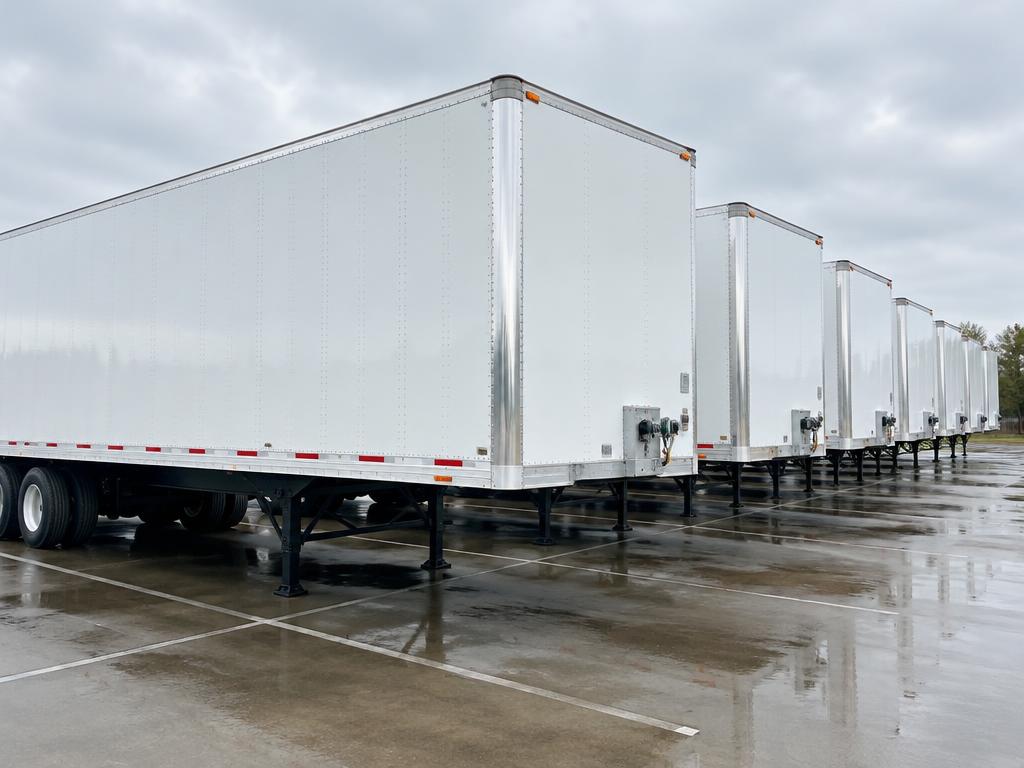 Clean white commercial trailers in a row